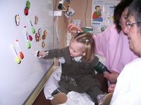 Une petite fille est en train de dessiner sur le tableau blanc