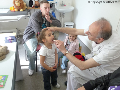 Le médecin anesthésiste pratique l'examen de la bouche d'une petite fille